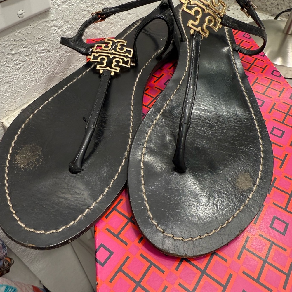 Tory Burch Black and Gold Thong Sandals with Metallic Ornament